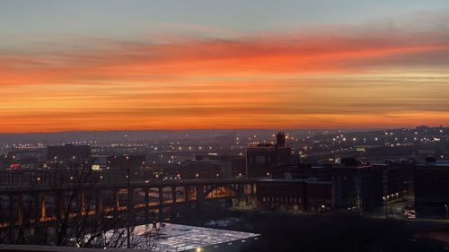 High angle view of illuminated buildings against sky during sunset