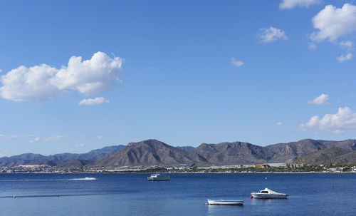 Sailboats in sea against sky