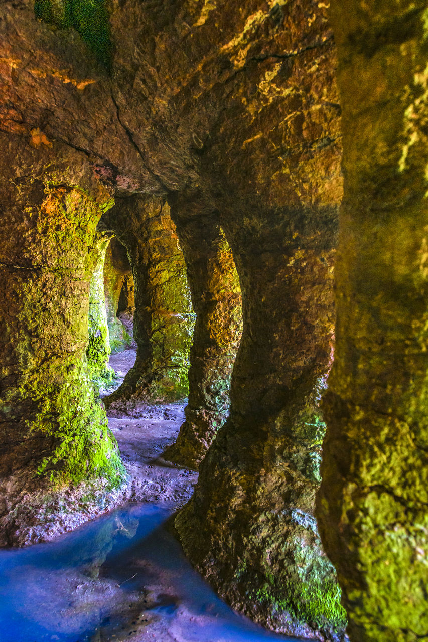 cave, nature, rock, no people, water, beauty in nature, plant, rock formation, tree, land, formation, sea cave, outdoors, day, arch, architecture, tranquility, scenics - nature, reflection, travel destinations, forest, environment, travel, sunlight, non-urban scene, autumn