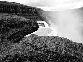 Scenic view of waterfall against sky