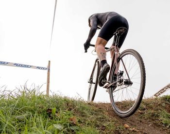 Man with bicycle on field