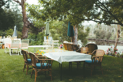 Empty chairs and table in park