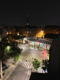 High angle view of illuminated road by buildings in city at night