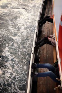 People relaxing on boat in sea