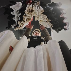 Portrait of a smiling woman sitting on ceiling