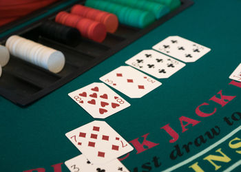 Close-up of cards with gambling chips at casino