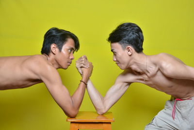 Young men doing arm wrestling