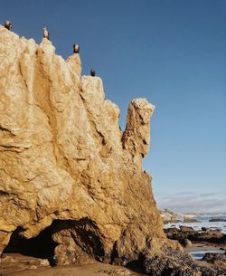 Low angle view of rock formation against clear sky
