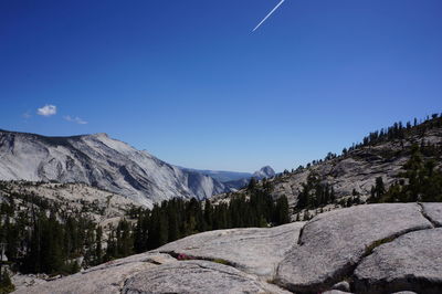 Scenic view of mountains against clear blue sky