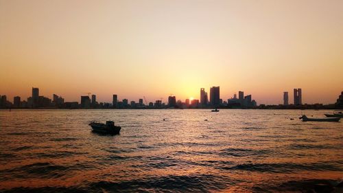 City at waterfront during sunset