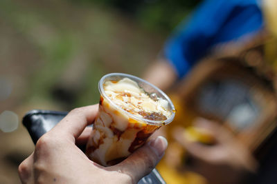 Close-up of hand holding ice cream