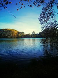 Scenic view of lake against sky at sunset