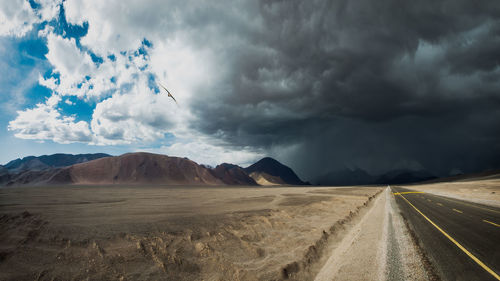 Panoramic view of desert road against sky