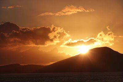 Scenic view of snowcapped mountains against sky during sunset