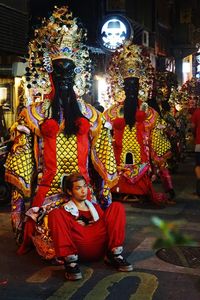 Man statue in traditional clothing at night