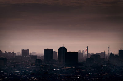 High angle view of buildings in city during sunset