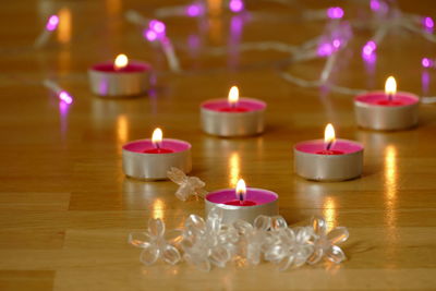 Close-up of lit candles on table