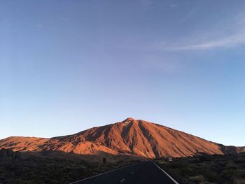 Volcanic mountain against clear blue sky