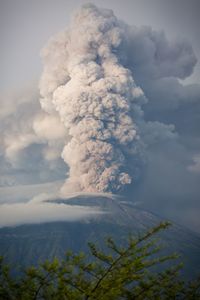 Smoke emitting from volcanic mountain against sky