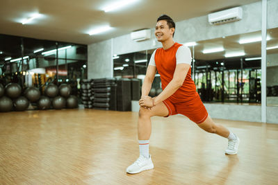 Young woman exercising in gym