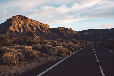 View of mountain road against cloudy sky