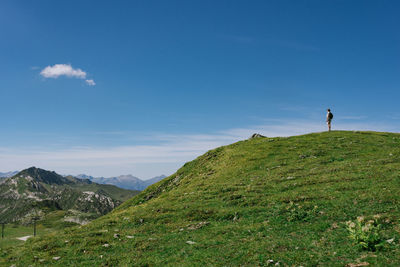 Man standing on mountain against sky