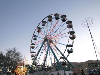 Low angle view of ferris wheel against sky