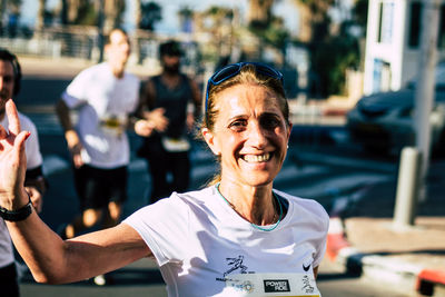 Portrait of smiling woman with city in background