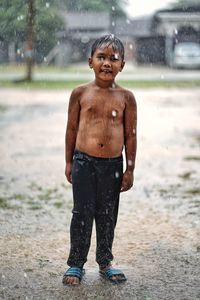 Full length of shirtless boy on water