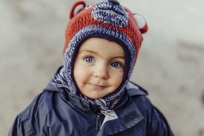 Portrait of cute baby girl wearing warm clothing outdoors