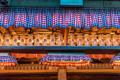 Close-up of illuminated beer mugs