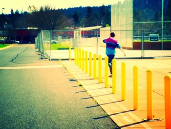 Full length of woman standing by railing