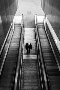 Rear view of man on escalator