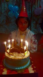 Illuminated candles on cake