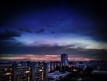 View of cityscape against cloudy sky