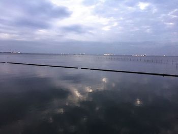 View of calm sea against cloudy sky