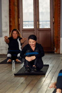 Portrait of young woman exercising in gym