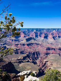 Scenic view of dramatic landscape against blue sky