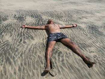 Full length of man on sand at beach