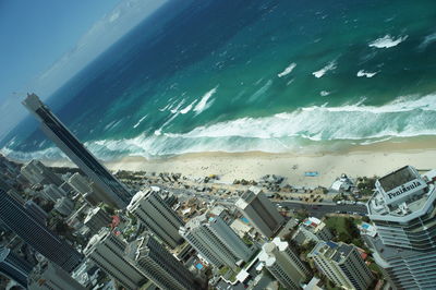 High angle view of cityscape by sea against sky