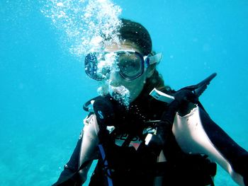 Portrait of mature woman scuba diving in sea