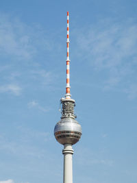 Low angle view of communications tower against sky