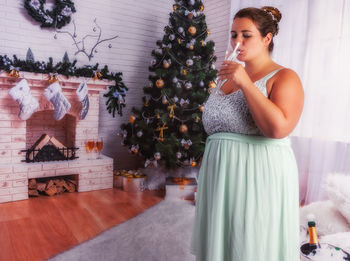 Woman on christmas tree at home