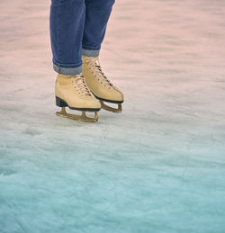 Low section of man ice skating