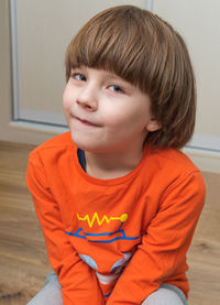 Portrait of boy sitting at home