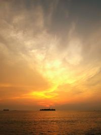 Silhouette boat sailing in sea against sky during sunset