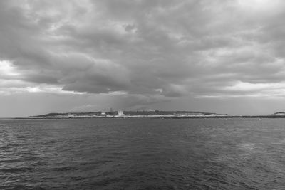 Scenic view of sea against cloudy sky