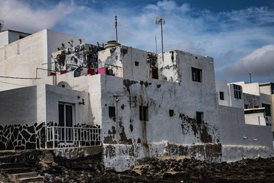 Low angle view of abandoned building against sky