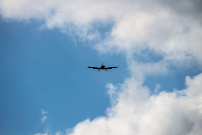 Low angle view of airplane flying in sky