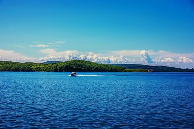 Scenic view of sea against blue sky